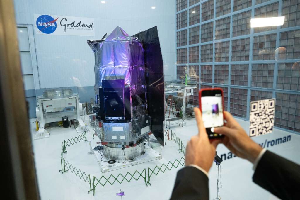 A journalist photographs the Nancy Grace Roman Space Telescope as it is unveiled to the public, at NASA's Goddard Space Flight Center in Greenbelt, Maryland on April 21, 2026.