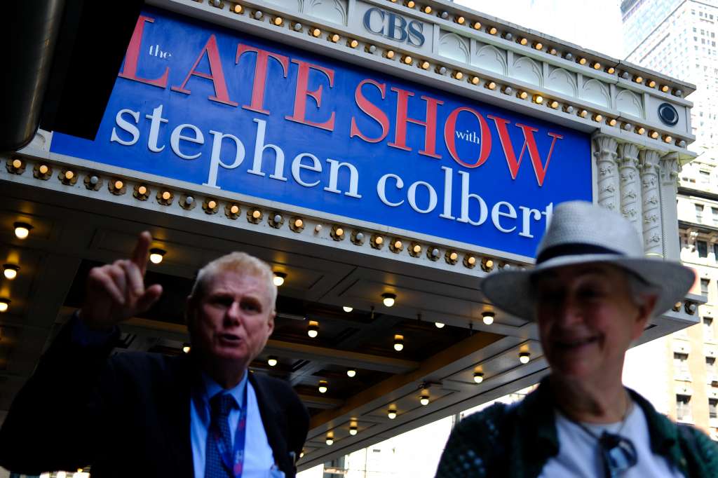 People line up outside the Ed Sullivan Theater where "The Late Show with Stephen Colbert," is produced in New York City on July 21, 2025.
