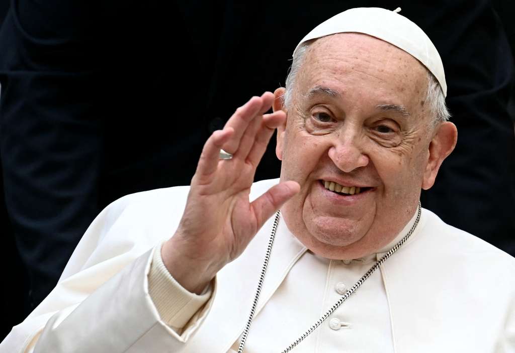 TOPSHOT - Pope Francis waves as he arrives to attend the unveil of a new electric popemobile, at the Vatican on December 4, 2024.