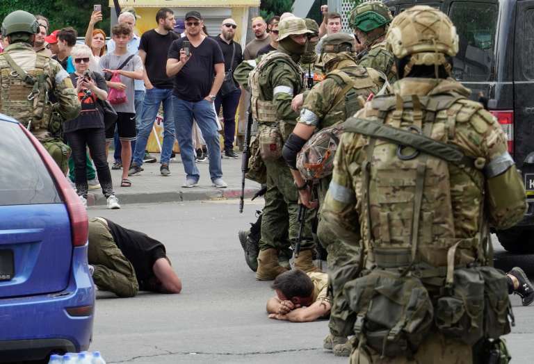 Rostov-on-don (Russian Federation), 23/06/2023.- Servicemen from private military company (PMC) Wagner Group detain some civilians as they block a street in downtown Rostov-on-Don, southern Russia, 24 June 2023. Security and armoured vehicles were deployed after Wagner Group's chief Yevgeny Prigozhin said in a video that his troops had occupied the building of the headquarters of the Southern Military District, demanding a meeting with Russia'Äôs defense chiefs. (Rusia) EFE/EPA/STRINGER