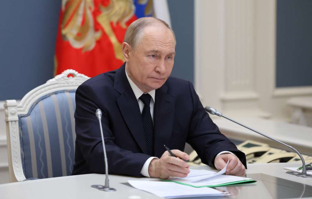 In this pool photograph distributed by the Russian state agency Sputnik, Russia's President Vladimir Putin oversees an exercise of the country's nuclear forces via a videolink in Moscow on October 22, 2025. (Photo by Alexander KAZAKOV / POOL / AFP)
