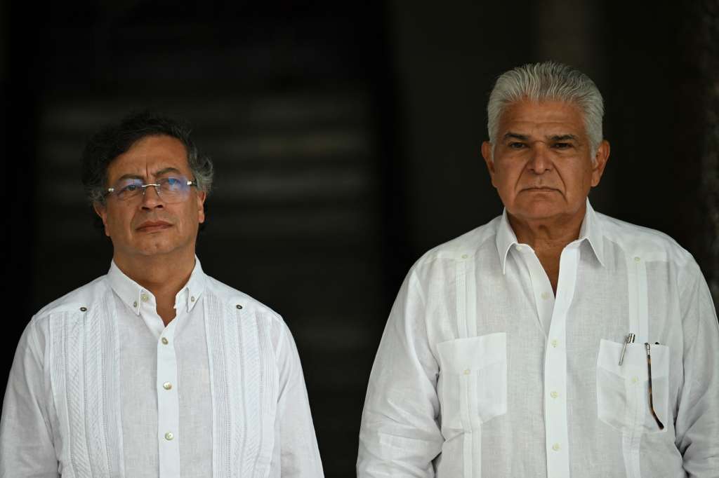 Panama's President Jose Raul Mulino (R) and Colombia's President Gustavo Petro stand on arrival for a meeting at Las Garzas presidential palace in Panama City on March 28, 2025.