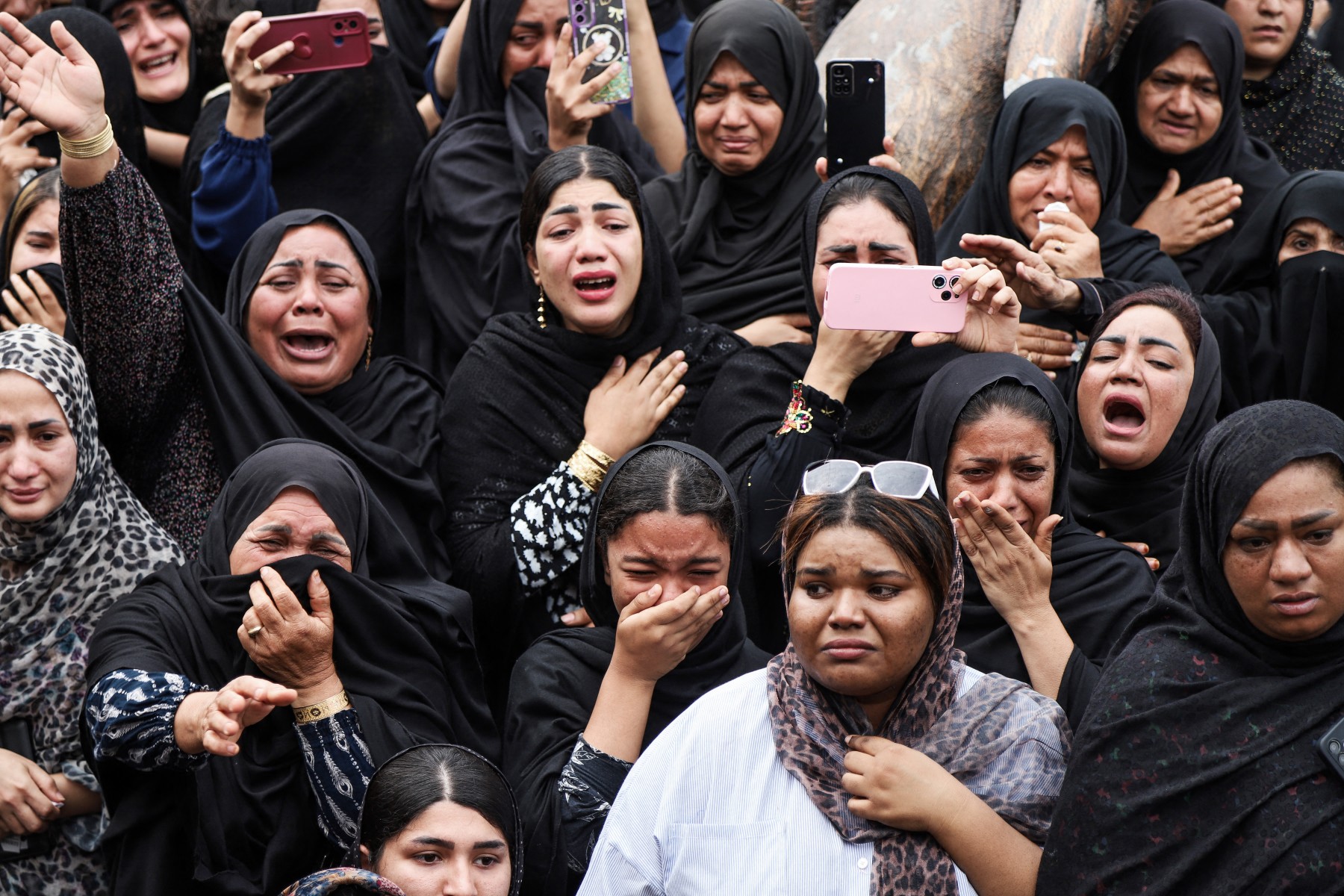 In this picture obtained from Iran's ISNA news agency, mourners cry during the funeral of children killed in a reported strike on a primary school in Iran�s Hormozgan province, in Minab on March 3, 2026. Iranian media have reported hundreds of Iranian casualties, including at a girl's school, although AFP reporters have not been able to verify tolls independently. The war launched by the United States and Israel against Iran spread across the Middle East, threatening to plunge the global economy into chaos, with Lebanon and Gulf energy exporters dragged into the conflict. (Photo by AMIRHOSSEIN KHORGOOEI / ISNA / AFP)