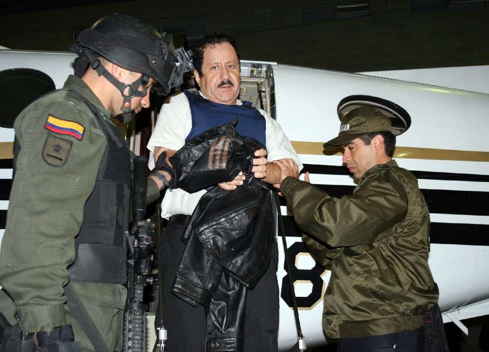 Miembros de la Policía Nacional custodian al exjefe de las Autodefensas Unidas de Colombia (AUC) Hernán Giraldo, el 13 de mayo de 2008. 