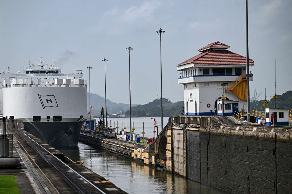 (FILES) A car carrier ship sails through the Pedro Miguel Locks during maintenance work at the Panama Canal, on the outskirts of Panama City on May 30, 2025. Panama earned record revenue from its interoceanic canal operations last year, marked by a recovery in transits following a drought, the canal authority reported on December 17, 2025. (Photo by MARTIN BERNETTI / AFP)
