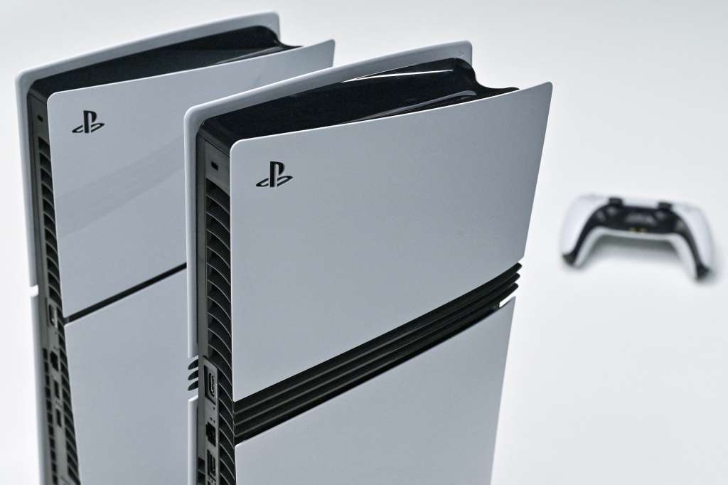 (FILES) This photo illustration shows a Sony PlayStation 5 (L) and 5 Pro (C) on display at the Sony headquarters building in central Tokyo on November 27, 2024.