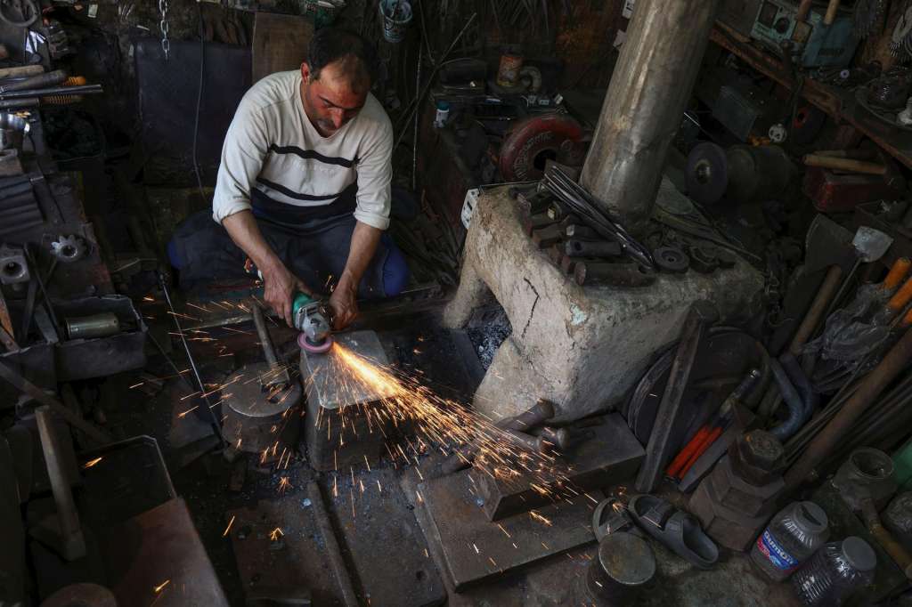 SRINAGAR (India), 03/08/2026.- A blacksmith grinds a piece of iron at his workshop in Srinagar,, the summer capital of Indian Kashmir, 03 August 2026. Handmade blacksmithing is a traditional craft in Kashmir in which artisans heat, hammer and shape iron by hand to make agricultural tools, household implements and other utility items. Once an essential part of rural life, the centuries-old craft is now facing a gradual decline due to industrial production, changing consumer preferences and the dwindling number of young people willing to carry forward the physically demanding trade. EFE/EPA/FAROOQ KHAN