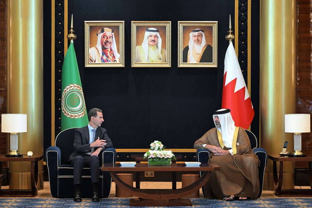 This handout picture from the official Bahrain News Agency (BNA) shows the reception of Syria's President Bashar al-Assad (L) in Manama on May 16, 2024 ahead of the 33rd Arab League Summit.