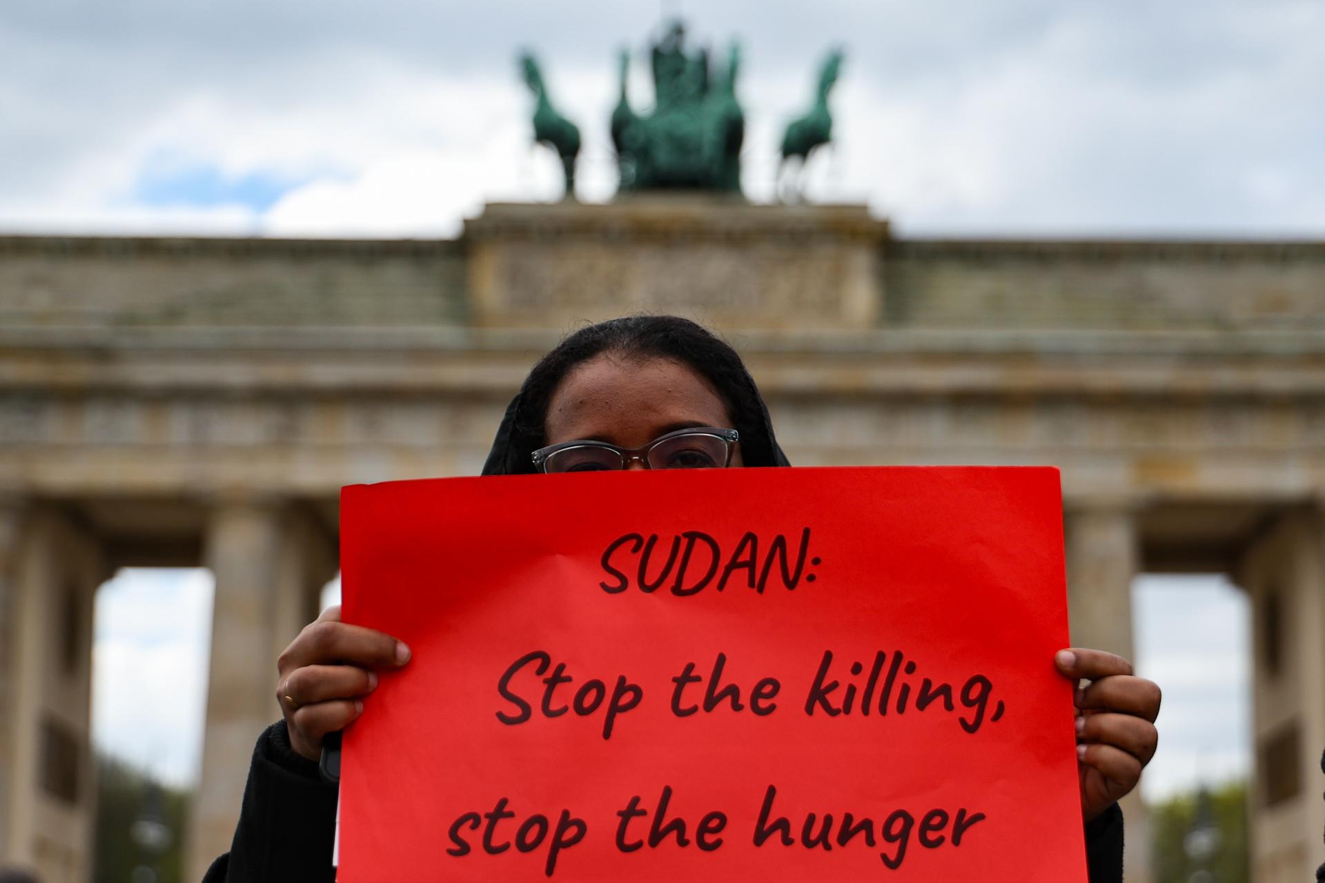 Berlin (Germany), 15/04/2025.- A woman holds a sign as she attends a protest against civil war in Sudan in front of Brandenburg Gate in Berlin, Germany, 15 April 2025. Diplomats and aid representatives from across the globe meet in London in an effort to alleviate the suffering caused by Sudan’s ongoing two-year war, a conflict responsible for tens of thousands of deaths, the displacement of 14 million people, and widespread famine.  (Protestas, Alemania, Londres) EFE/EPA/FILIP SINGER
