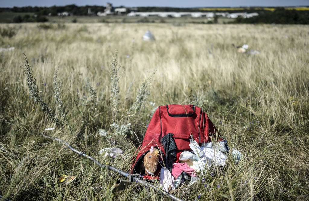 (FILES) Belongings of victims are seen at the crash site of the Malaysia Airlines flight MH17, in a field near the village of Grabove, in the Donetsk region on July 23, 2014.