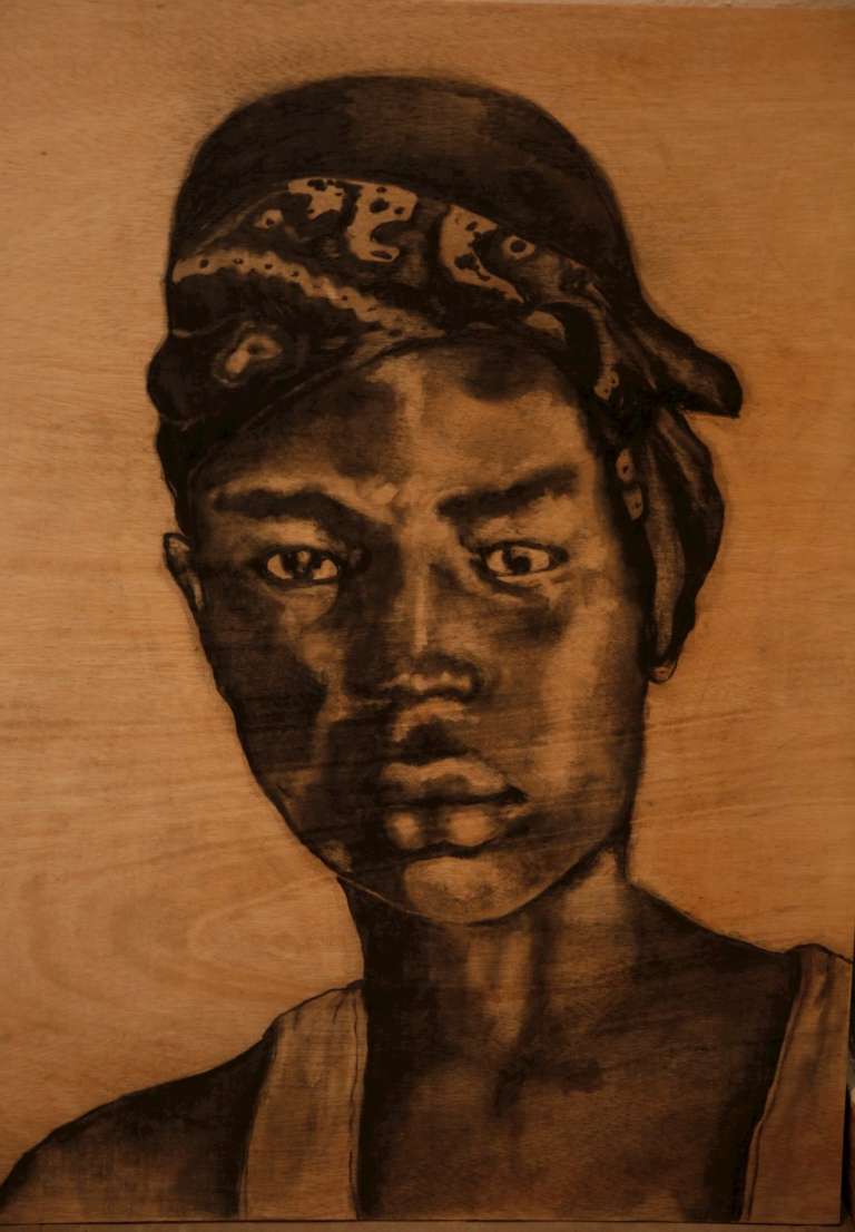 Reproducción fotográfica de un retrato hecho con ceniza de Leyder Cárdenas, uno de los cinco jóvenes asesinados en Llano Verde.