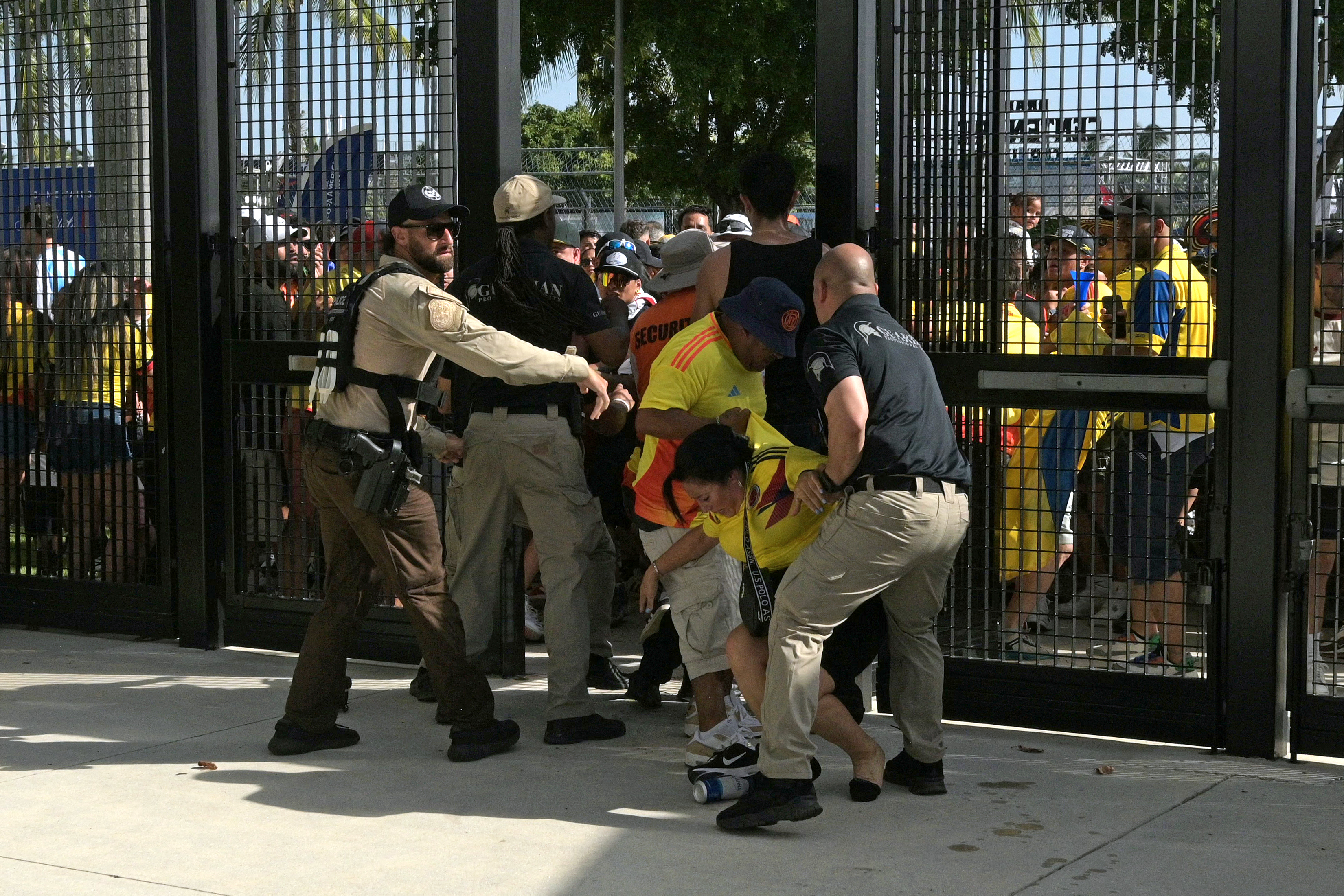 La policía de Estados Unidos contiene a varios hinchas en la entrada del estadio en Miami.