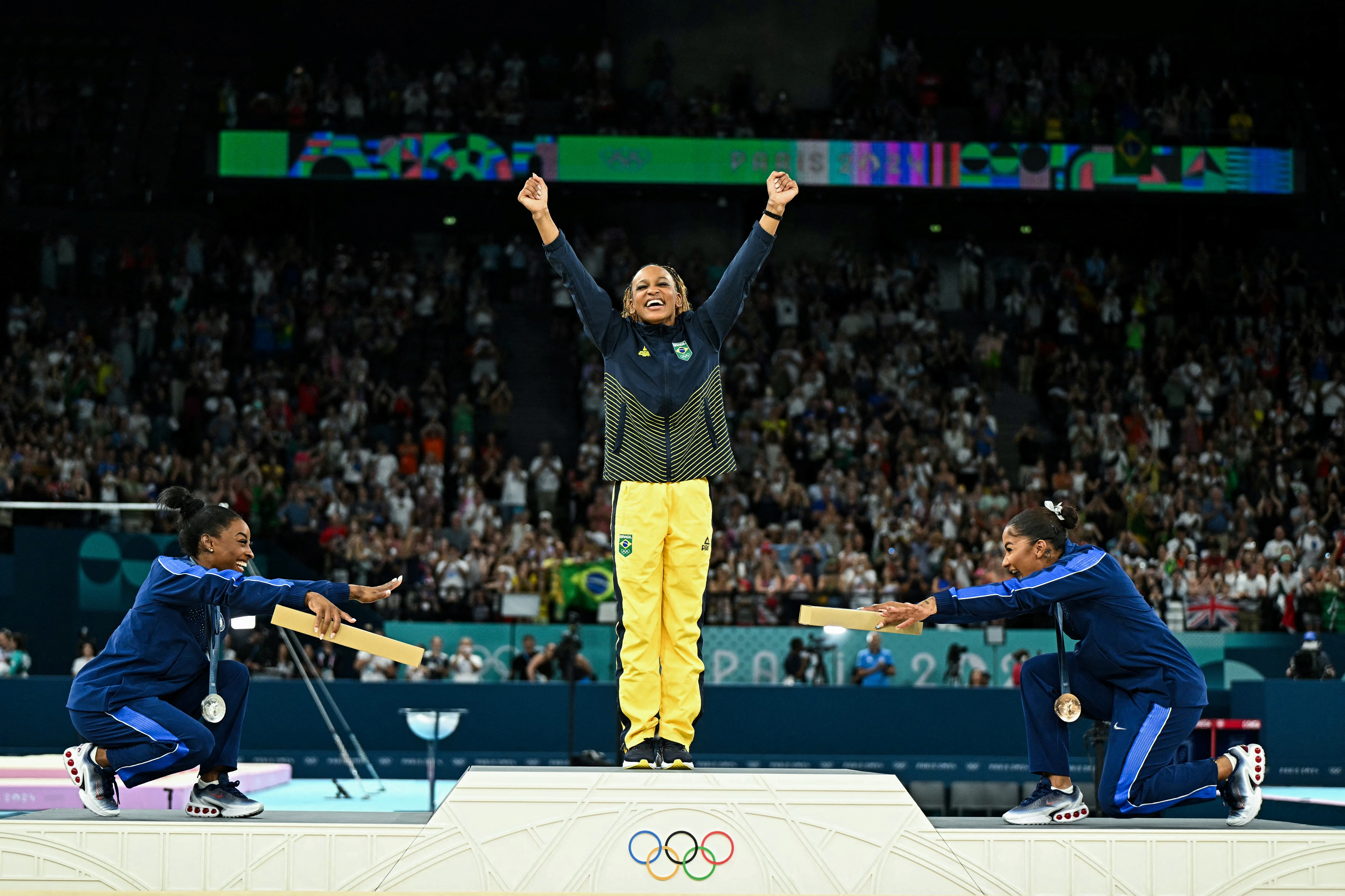 (De izquierda a derecha) La estadounidense Simone Biles (plata), la brasileña Rebeca Andrade (oro) y la estadounidense Jordan Chiles (bronce) posan durante la ceremonia del podio de la prueba de gimnasia artística femenina de suelo de los Juegos Olímpicos de París 2024.