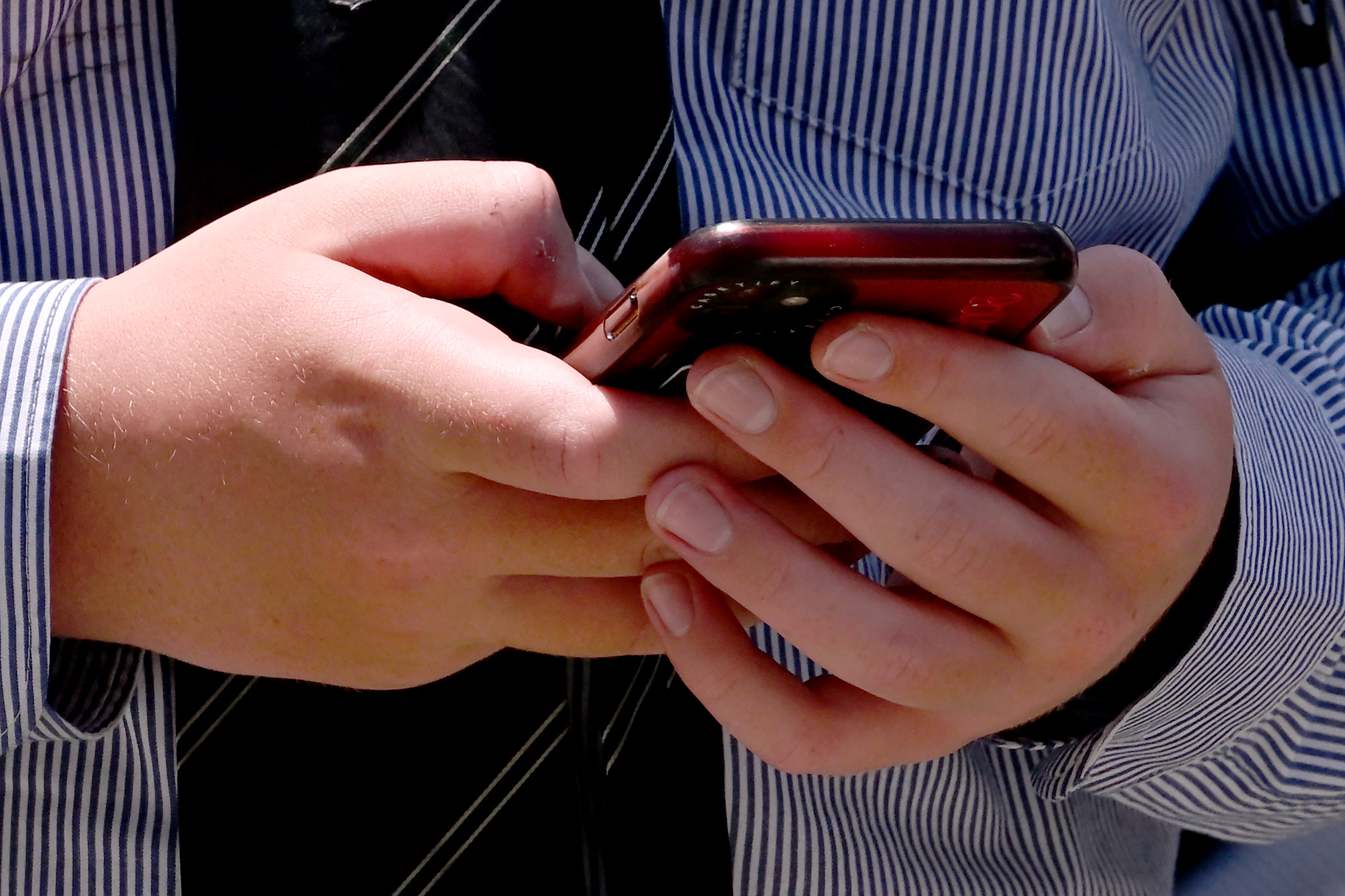 (FILES) A student uses his phone in Melbourne on November 27, 2024, as Australia looks to ban children under 16 from social media with claims social media platforms have been tarnished by cyberbullying, the spread of illegal content, and election-meddling claims.