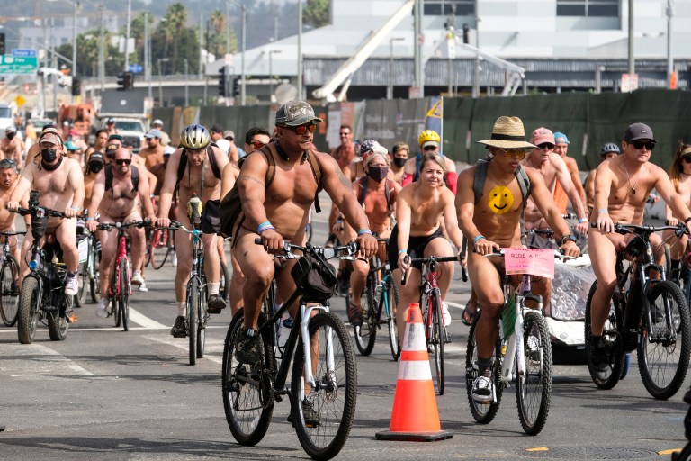 EDITORS NOTE: Graphic content / Nude cyclists get ready for the World Naked Bike Ride on September 18, 2021 in downtown Los Angeles. (Photo by RINGO CHIU / AFP)