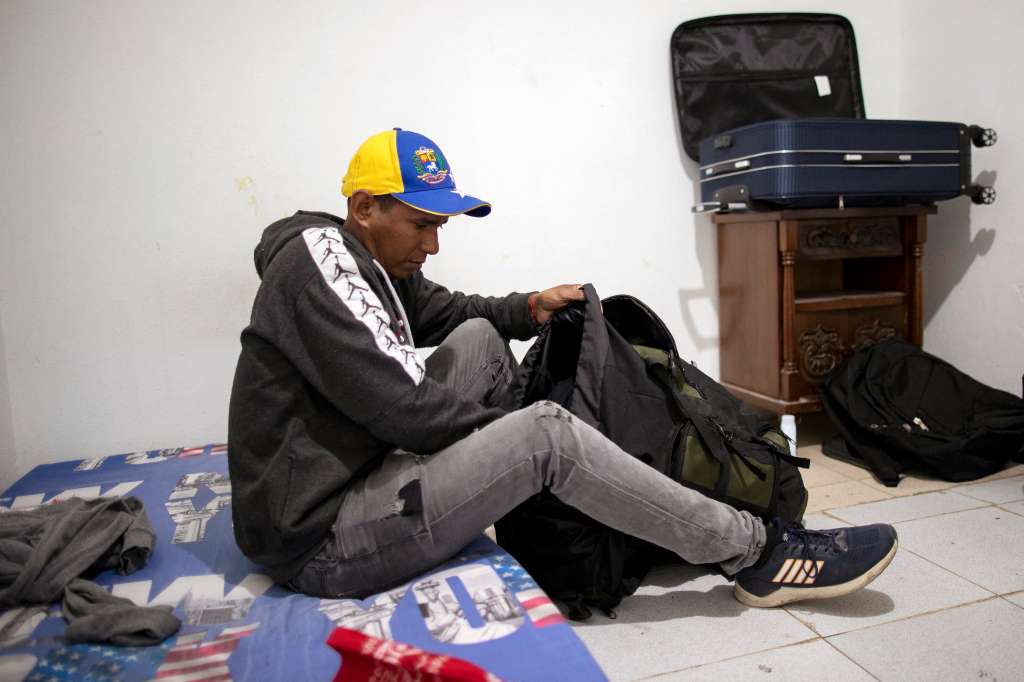 Jose Ochoa from Venezuela packs his belongings as he prepares to travel to US via Darien gap, in Madrid, near Bogota on August 6, 2024.