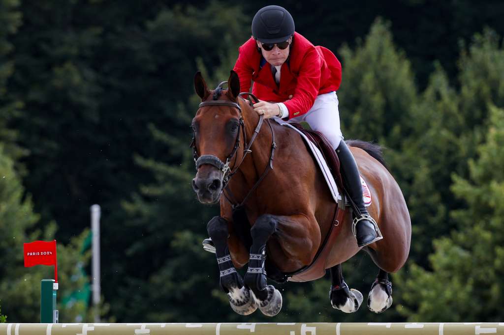 TOPSHOT - US' Karl Cook with horse Caracole De La Roque competes in the equestrian's jumping team final during the Paris 2024 Olympic Games at the Chateau de Versailles, in Versailles, in the western outskirts of Paris, on August 2, 2024. (Photo by Pierre-Philippe MARCOU / AFP)