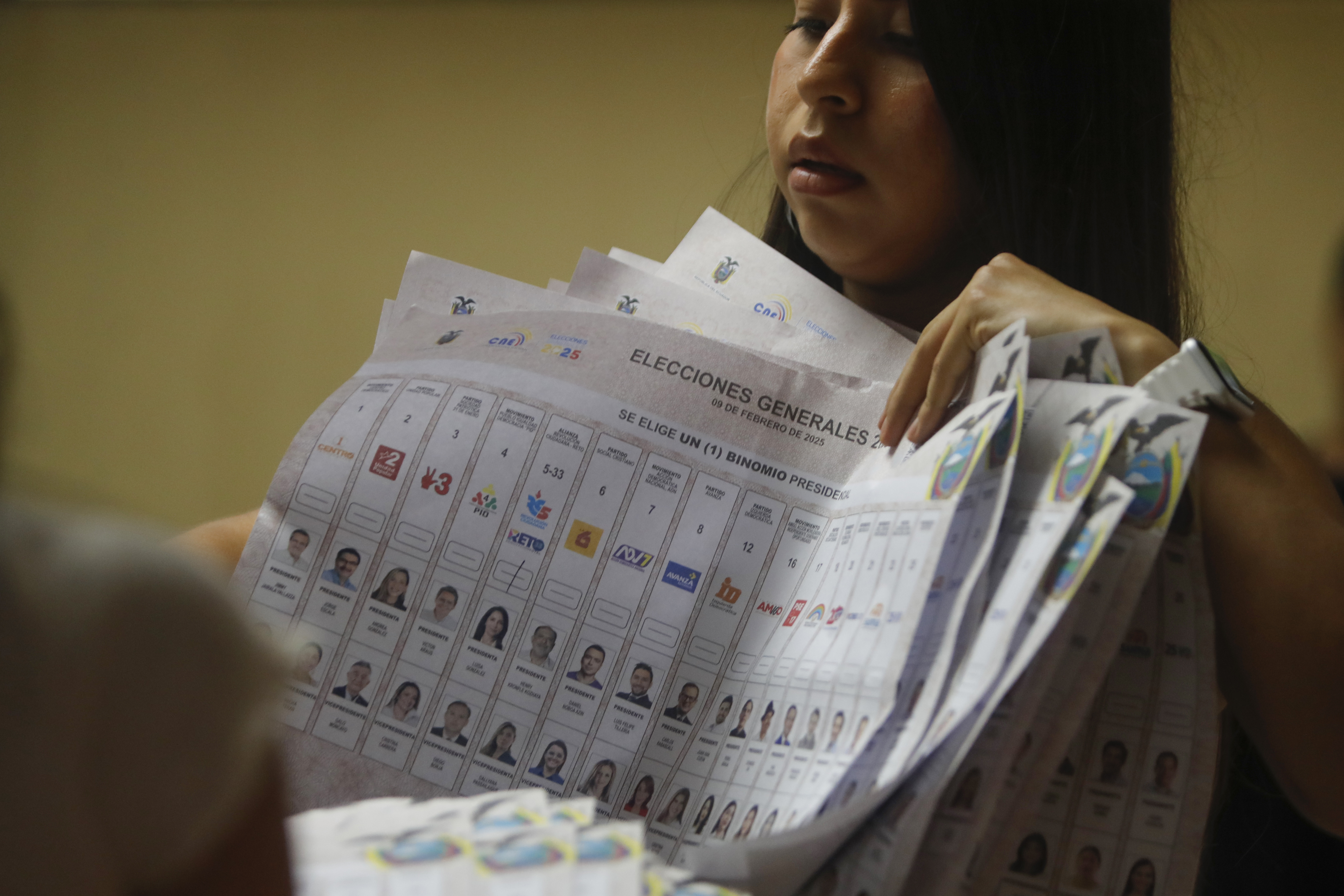 AMDEP2252. OLÓN (ECUADOR), 09/02/2025.- Un miembro de mesa cuenta votos al cierre de la jornada electoral este domingo, en Guayaquil (Ecuador). Los primeros resultados del conteo oficial de las elecciones presidenciales celebradas este domingo en Ecuador alejan las posibilidades de que Noboa, logre la reelección en primera vuelta, a pesar de la diferencia alcanzada con respecto a la candidata del correísno, Luisa González. EFE/ Carlos Durán Araújo