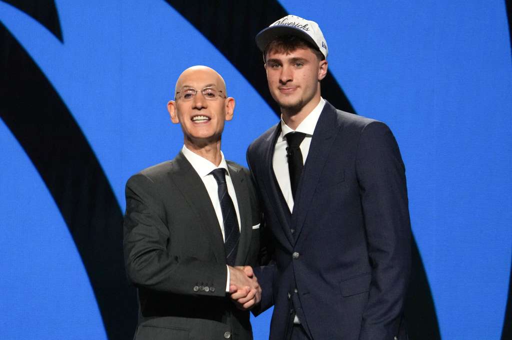 TOPSHOT - US basketball player Cooper Flagg (R) shakes hands with NBA Commissioner Adam Silver after being selected first overall by the Dallas Mavericks during the opening round of the 2025 NBA Draft at Barclays Center in Brooklyn, New York, on June 25, 2025.