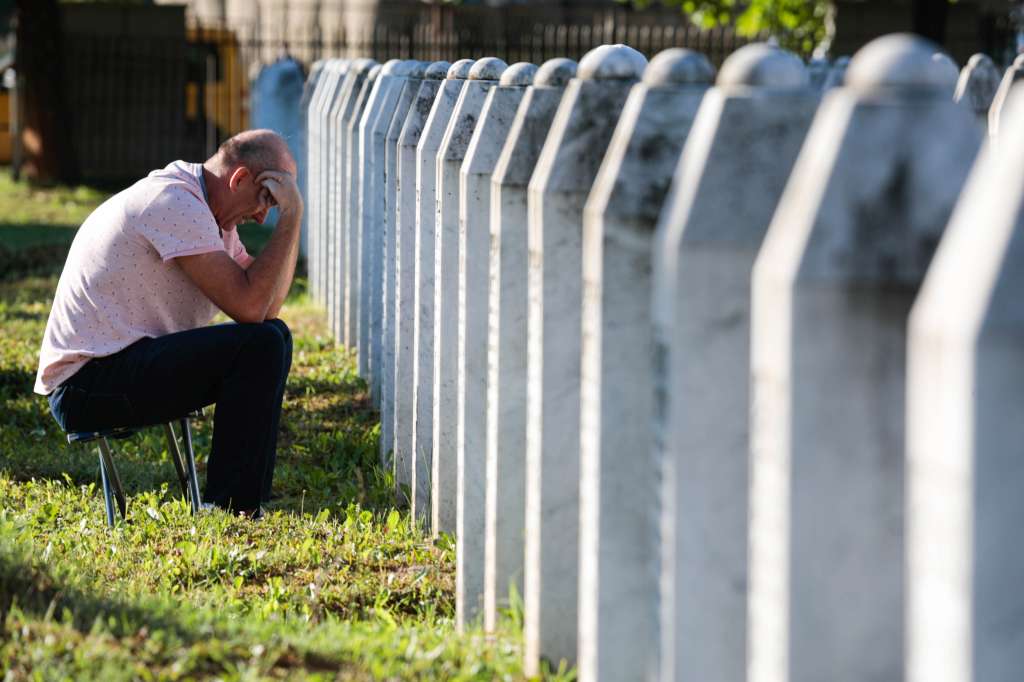 Srebrenica (Bosnia And Herzegovina), 11/07/2022.- A Bosnian Muslim man visits gravestones during a funeral ceremony for fifty newly-identified Bosnian Muslim victims, at the Potocari Memorial Center and Cemetery in Srebrenica, Bosnia and Herzegovina, 11 July 2022. The burial was part of a memorial ceremony to mark the 27th anniversary of the Srebrenica genocide, considered the worst atrocity of Bosnia's 1992-95 war. More than 8,000 Muslim men and boys were executed in the 1995 killing spree after Bosnian Serb forces overran the town. (Bosnia-Herzegovina) EFE/EPA/JASMIN BRUTUS