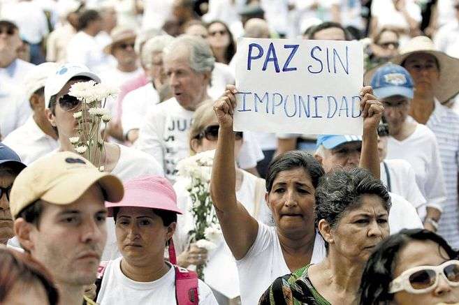 Marcha ciudadana. Una mujer sostiene un cartel que dice "Paz sin impunidad".