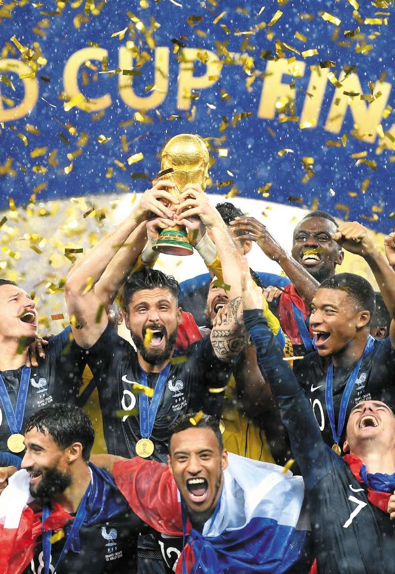 MOSCOW, RUSSIA - JULY 15: Olivier Giroud of France celebrates with the World Cup Trophy and his teammates following his sides victory in the 2018 FIFA World Cup Final between France and Croatia at Luzhniki Stadium on July 15, 2018 in Moscow, Russia. (Photo by Matthias Hangst/Getty Images)