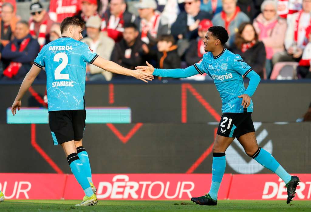 Cologne (Germany), 03/03/2024.- Leverkusen's Amine Adli (R) celebrates with teammate Josip Stanisic after his assist for the 2-0 lead during the German Bundesliga soccer match between 1. FC Cologne and Bayer 04 Leverkusen in Cologne, Germany, 03 March 2024. (Alemania, Colonia) EFE/EPA/RONALD WITTEK CONDITIONS - ATTENTION: The DFL regulations prohibit any use of photographs as image sequences and/or quasi-video.