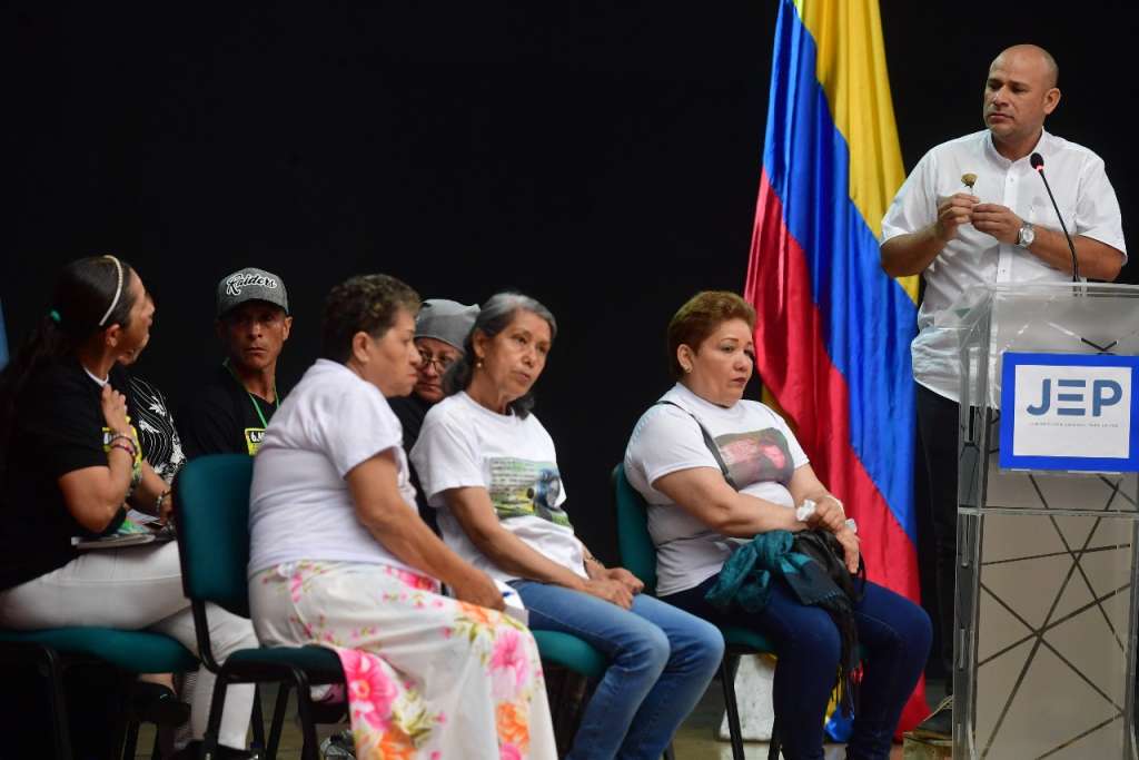 Sandro Pérez muestra una flor a Flor Hilda Hernández, una de las madres de Soacha