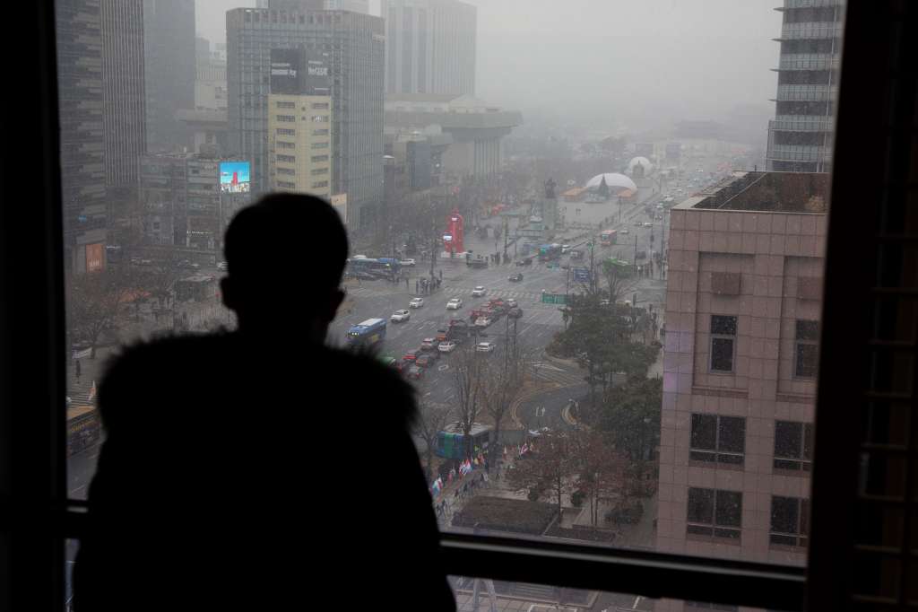 Seoul (Korea, Republic Of), 17/01/2024.- North Korean defector Mr. Kim views the city center area through a window, in Seoul, South Korea, 17 January 2024 (issued 22 January 2024). Mr. Kim is one of few North Koreans who managed to flee and directly reach the South between 2020 and 2023 due to strict border closures during the Covid pandemic. On the night of 06 May 2023, he and his family were able to quietly sail through patrolled waters in the Yellow Sea and cut across the maritime border between both Koreas. Mr. Kim has refused to give his full name in order to protect relatives on both sides of the border. (Corea del Sur, Seúl) EFE/EPA/JEON HEON-KYUN