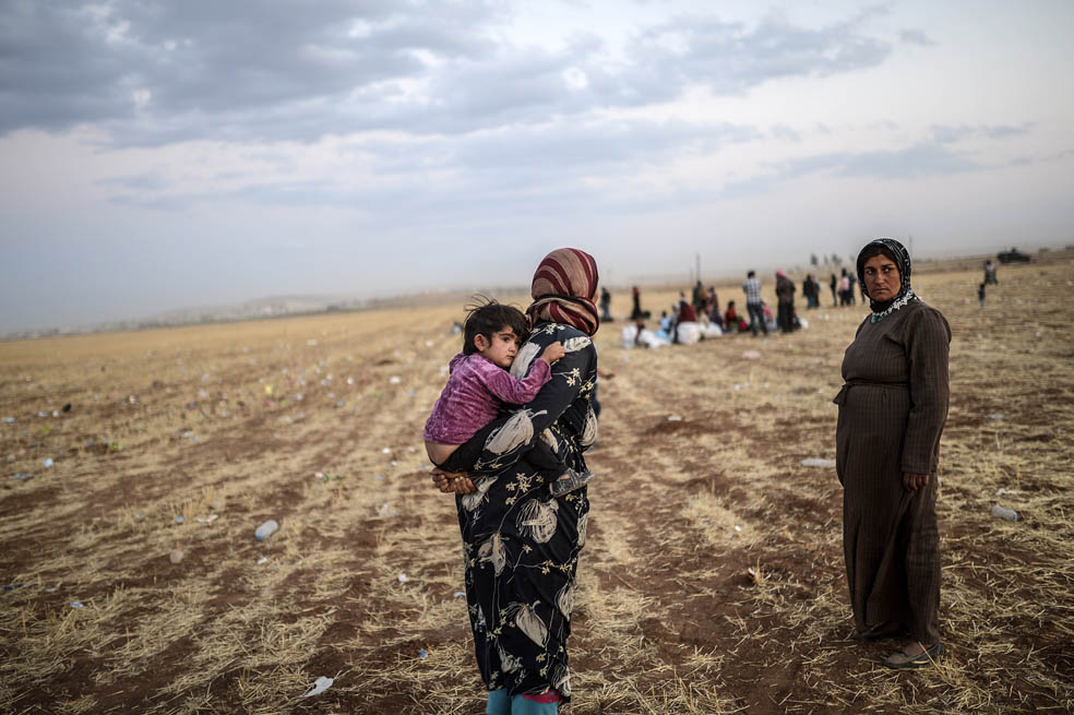 Kurdos sirios huyen hacia Turquía frente a la avanzada del EI, que hoy amenaza la estratégica población de Kobani. / AFP