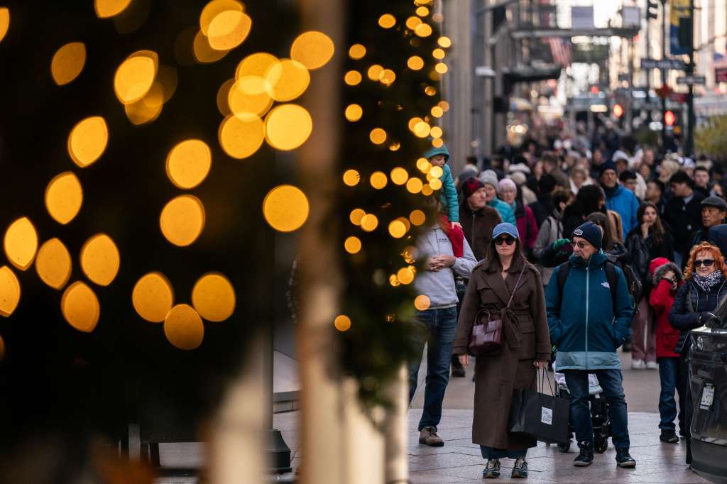 People carry shopping bags on Fifth Avenue on Black Friday, in New York City on November 29, 2024.