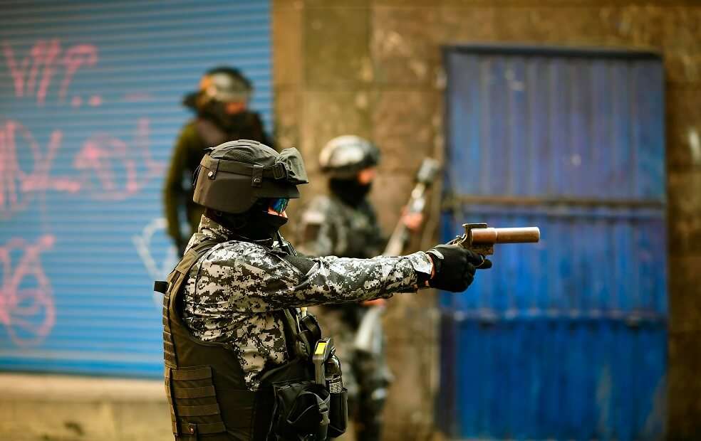 La policía antidisturbios dispara contra partidarios del ex presidente boliviano Evo Morales durante una protesta contra el gobierno interino en La Paz el 15 de noviembre de 2019. / AFP