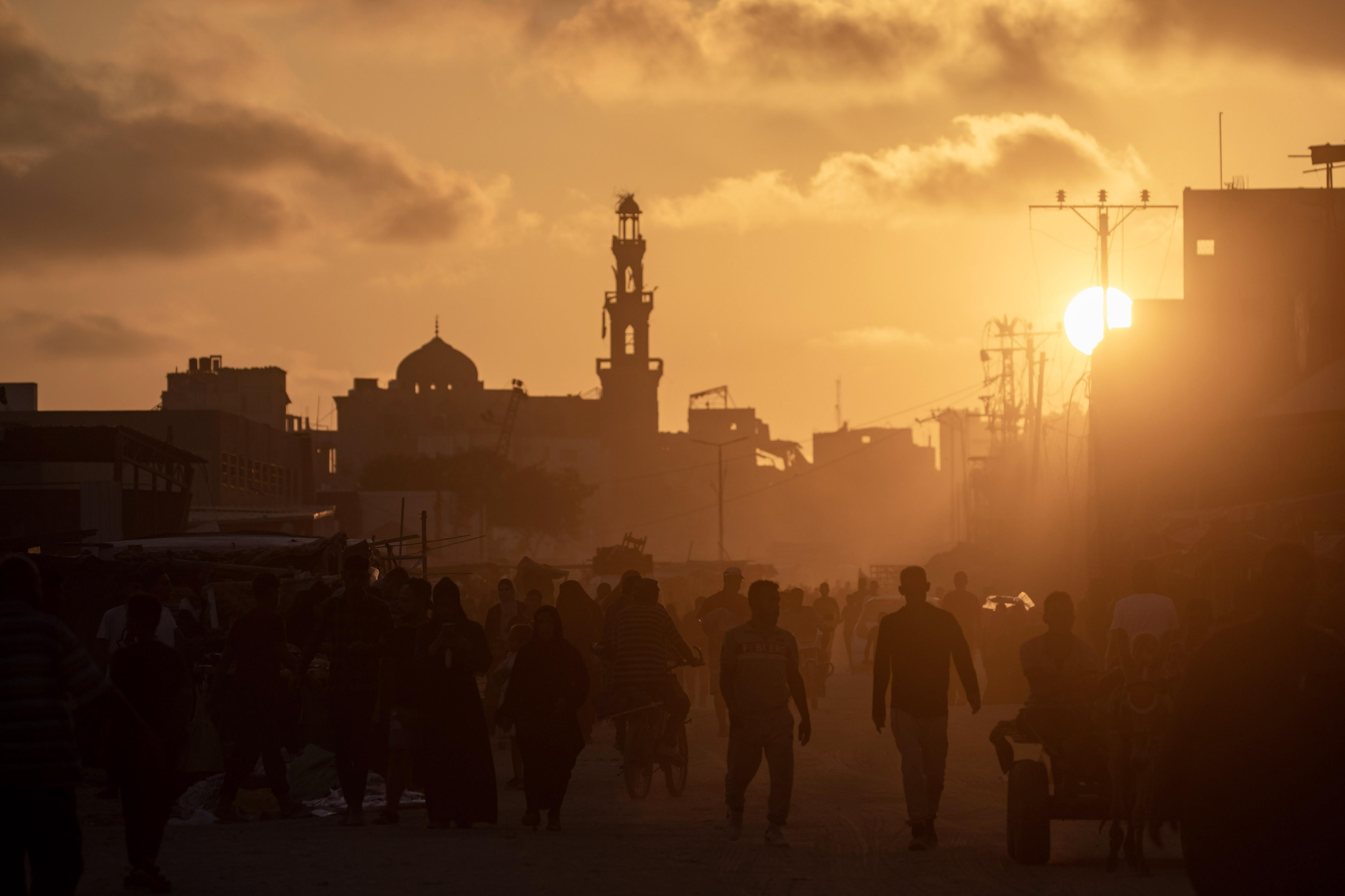 Khan Yunis (-), 11/06/2024.- Palestinians walk at sunset in a destroyed street of Khan Yunis refugee camp, southern Gaza Strip, 11 June 2024. More than 37,000 Palestinians and over 1,400 Israelis have been killed, according to the Palestinian Health Ministry and the Israel Defense Forces (IDF), since Hamas militants launched an attack against Israel from the Gaza Strip on 07 October 2023, and the Israeli operations in Gaza and the West Bank which followed it. EFE/EPA/HAITHAM IMAD