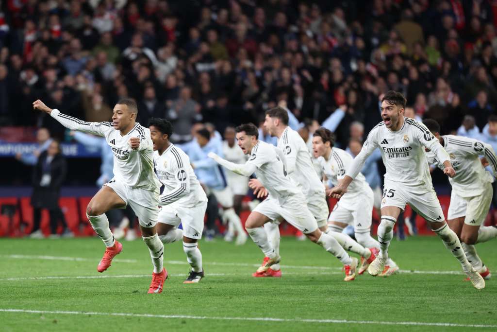 Real Madrid players celebrate their victory after the UEFA Champions League Round of 16 second leg football match between Club Atletico de Madrid and Real Madrid CF at the Metropolitano stadium in Madrid on March 12, 2025. (Photo by Thomas COEX / AFP)