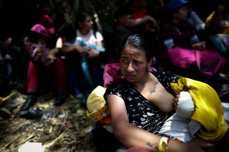 -FOTOGALERÍA- AME4250. BAJO CHIQUITO (PANAMÁ), 21/03/2023.- Jesenia Pérez amamanta a su hijo en la selva mientras esperan para ser trasladados en canoa desde la Quebrada León hasta a la comunidad de Bajo Chiquito, el 10 de marzo de 2023, en Darién (Panamá). "Guerreros", repiten las madres, hijos guerreros que han aguantado largas caminatas, hambre, sed, el calor, picaduras de insectos, superar ríos y cerros, para sobrevivir a la selva del Darién en su ruta hacia Estados Unidos. Recién salidos de esta selva que hace de frontera natural entre Colombia y Panamá, los migrantes llegan hasta la conocida como Quebrada del León, donde les esperan unas piraguas de indígenas que los descenderán por el casi seco río Tuquesa hasta Bajo Chiquito, una pequeña población emberá donde podrán al fin reposar tranquilos. Robaron al grupo de la venezolana Jessenia Pérez, de 30 años, que viaja con diez niños, entre hijos y sobrinos. La joven piensa en otros migrantes que intentarán como ellos atravesar la selva, y les lanza una recomendación que repiten otros recién llegados: "Si ustedes vienen, en grupos grandes, no se queden atrás, porque los que van atrás sufren lo peor, robo y de todo". EFE/ Bienvenido Velasco