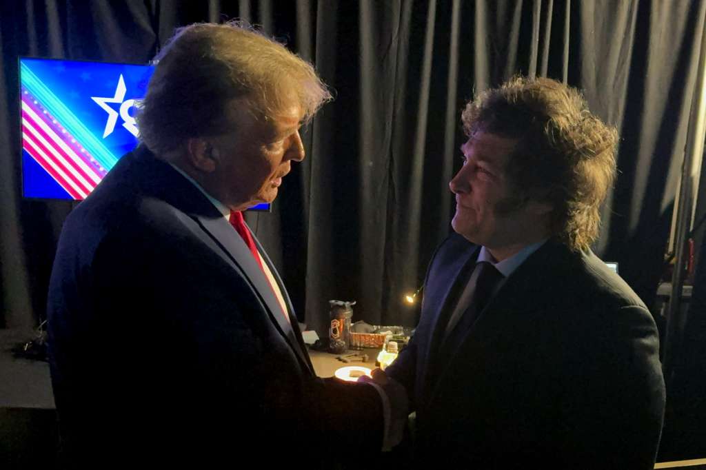 (FILES) A handout photo released by Argentina's Presidency shows President Javier Milei (R) and then former US President and 2024 presidential hopeful Donald Trump shaking hands at the annual Conservative Political Action Conference (CPAC) meeting on February 24, 2024, in National Harbor, Maryland.