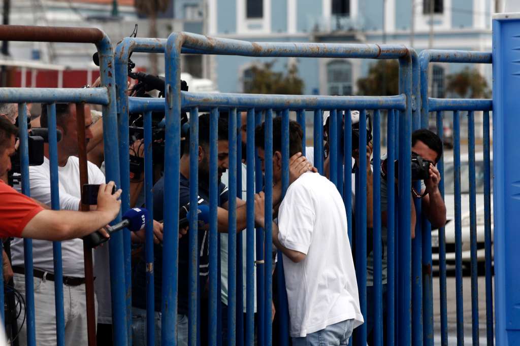 Kalamata (Greece), 16/06/2023.- Fardi (L) from Syria, hugs his rescued brother, Mohamed (R), between a fence, in the port of Kalamata Greece, 16 June 2023. The 104 people rescued after a migrant boat capsized off the coast of Pylos will be taken to a migrant reception facility in Malakasa. A total of 104 individuals were rescued, while 78 bodies were recovered, after a fishing boat capsized in international waters 47 nautical miles southwest of the Peloponnese coast and the town of Pylos. The number of people missing remains unknown. (Grecia, Siria) EFE/EPA/YANNIS KOLESIDIS
