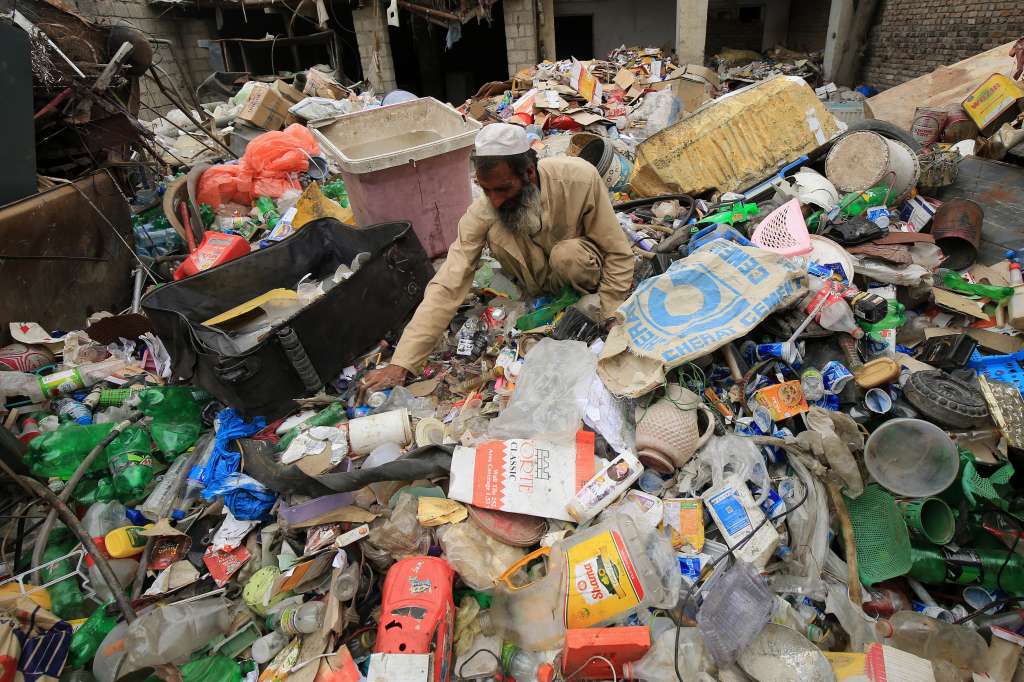 Peshawar (Pakistan), 22/04/2024.- A man works at a waste recycle plant, on World Earth Day in Peshawar, Pakistan, 22 April 2024. World Earth Day is celebrated annually on 22 April, to raise awareness and develop a sense of public responsibility pertaining to environmentally-sustainable practices in order to build and maintain a healthy, global ecosystem and maintain a viable planet for future generations. The theme for World Earth Day 2024 is Planet vs Plastics, to bring attention to the serious issue of plastic pollution and how it harms nature. EFE/EPA/BILAWAL ARBAB