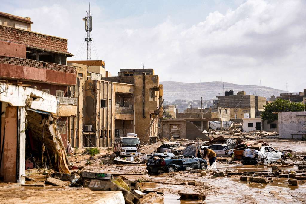 This handout picture provided by the office of Libya's Benghazi-based interim prime minister on September 11, 2023 shows a view of destroyed vehicles and damaged buildings in the eastern city of Derna, about 290 kilometres east of Benghazi, in the wake of the Mediterranean storm "Daniel". At least 150 people were killed when freak floods hit eastern Libya, officials said on September 11, after the storm's torrential rains battered Turkey, Bulgaria, and Greece. (Photo by The Press Office of Libyan Prime Minister / AFP) / === RESTRICTED TO EDITORIAL USE - MANDATORY CREDIT "AFP PHOTO / HO /MEDIA OFFICE OF LIBYAN PRIME MINISTER (BENGHAZI)" - NO MARKETING NO ADVERTISING CAMPAIGNS - DISTRIBUTED AS A SERVICE TO CLIENTS