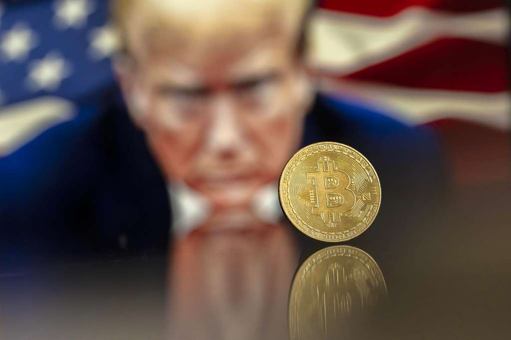Lugano (Switzerland), 22/11/2024.- (FILE) - An illustration shows a Bitcoin mockup in front of an image of US President-elect Donald Trump, 22 November 2024 (reissued 16 December 2024). The world's most popular cryptocurrency hit a new record high on 16 December 2024, briefly passing 106,000 dollars (100,800 euros). (Suiza) EFE/EPA/PABLO GIANINAZZI