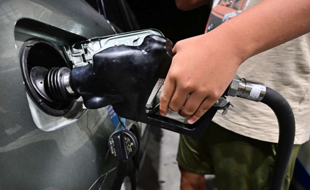 (FILES) A man pumps gas into a vehicle at a petrol station on October 2, 2023, in Alhambra, California.