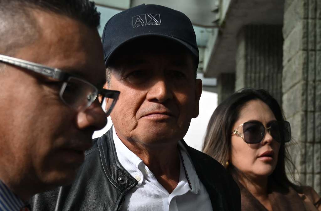 Former Colombian cyclist Luis "Lucho" Herrera (C) looks on as he arrives to deliver his statement to the prosecutor in a case of alleged alliance with paramilitary crimes at the Office of the Attorney General of Colombia in Bogota on June 5, 2025.
