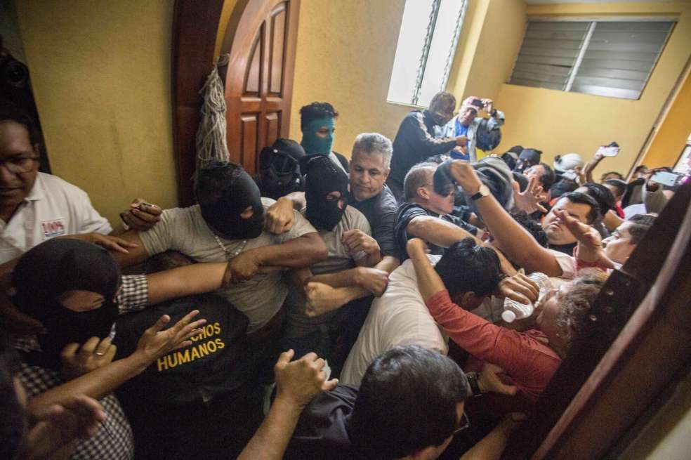 Un grupo de encapuchados agrede a varios obispos y periodistas tras irrumpir violentamente en la basílica de San Sebastián. / EFE