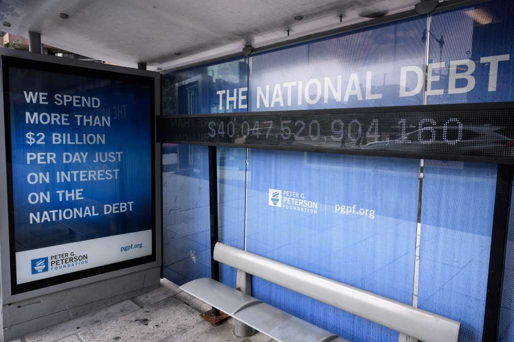 An electronic display shows the national debt in Washington, DC on August 19, 2026. The US national debt exceeded a record 40 trillion USD. The US gross national debt has surged past $40 trillion for the first time, government data showed Wednesday, outstripping earlier forecasts at a pace fuelled in part by President Donald Trump's invalidated tariffs. The uptick in borrowing comes as longer term US obligations linked to social security and health care have been growing, while interest payments have climbed as well. (Photo by Mandel NGAN / AFP)