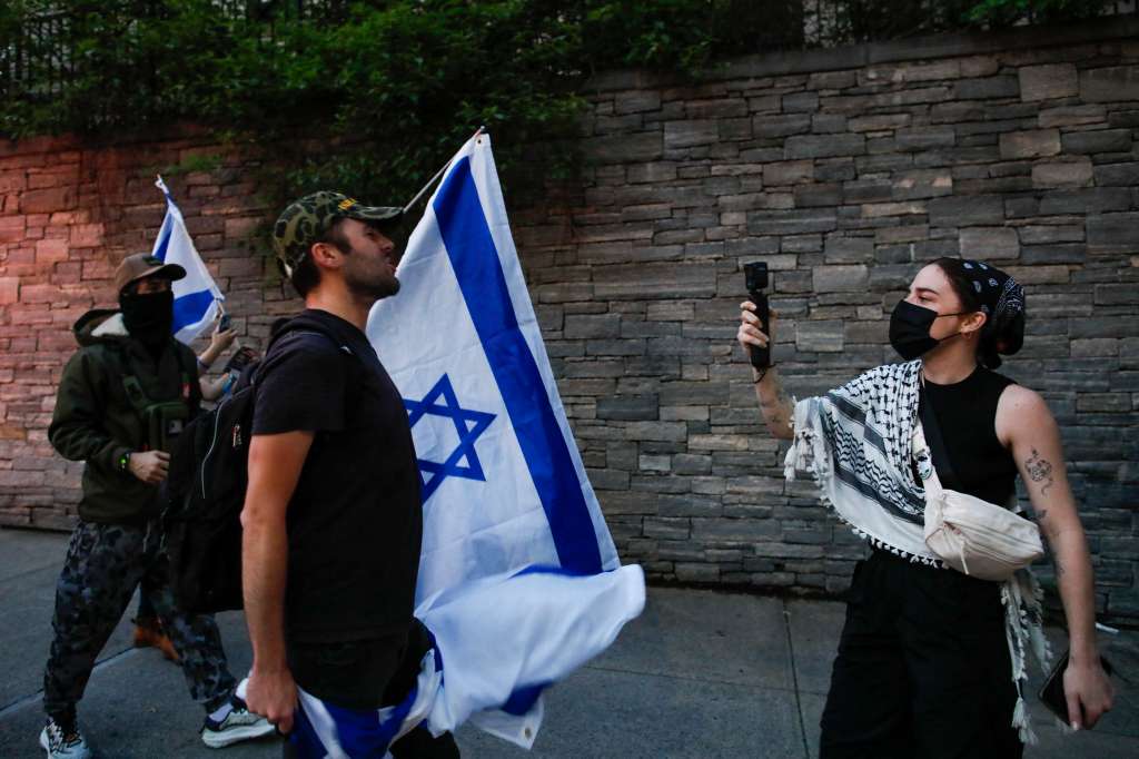 (FILES) A pro-Palestinian protestor (R) argues with pro-Israel protesters during a demonstration outside Columbia University, in New York City on May 23, 2024.