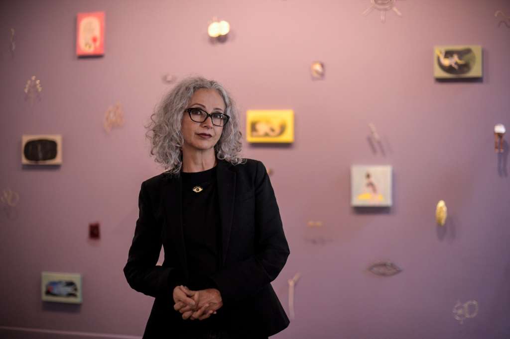Luz Lizarazo acompañada de algunas de las obras de su exposición “En el ojo nace la rosa”.