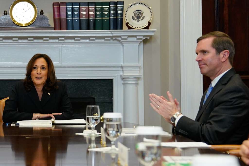 (FILES)  Kentucky Governor Andy Beshear (R) looks on as US Vice President Kamala Harris speaks during a roundtable conversation about marijuana reform and criminal justice reform, in the Roosevelt Room of the White House on March 15, 2024 in Washington, DC.