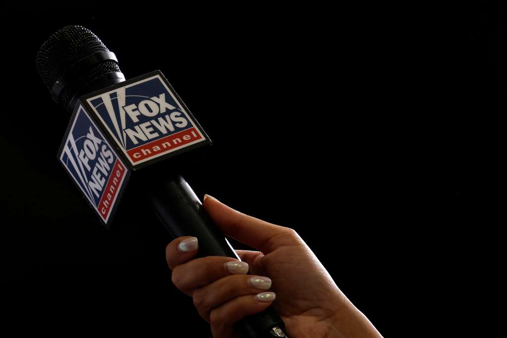 A Fox News reporter interviews someone before former US President and Republican presidential candidate Donald Trump delivers remarks on the economy, inflation, and manufacturing during a campaign event at Alro Steel in Potterville, Michigan, on August 29, 2024.