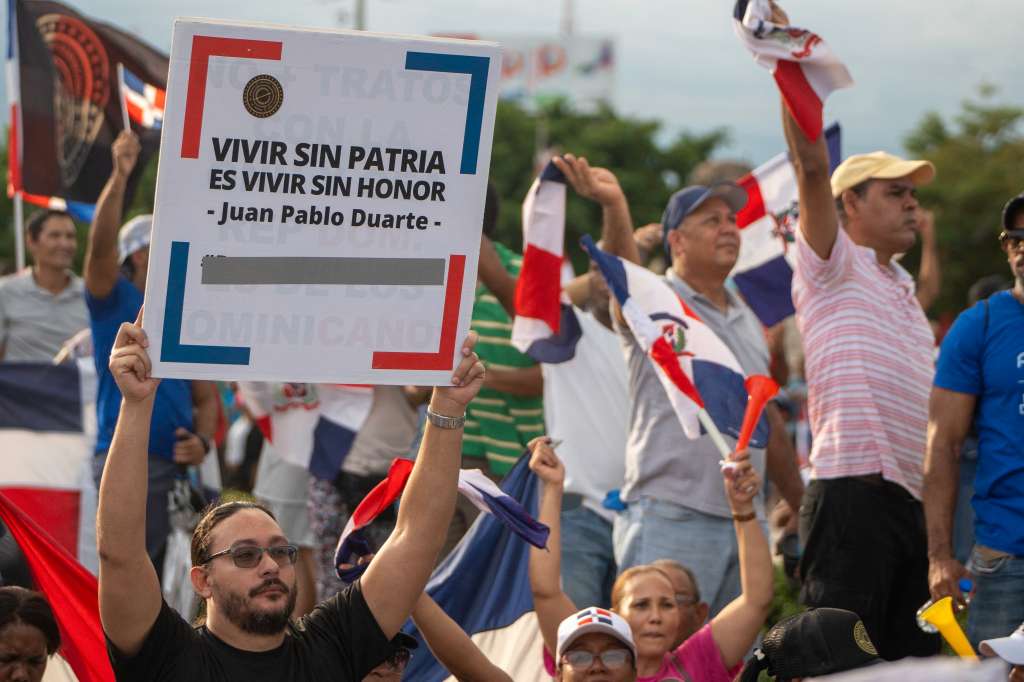 Demonstrators shout slogans during an anti-Haitian migration protest in Santo Domingo on October 5, 2024. (Photo by Francesco SPOTORNO / AFP)