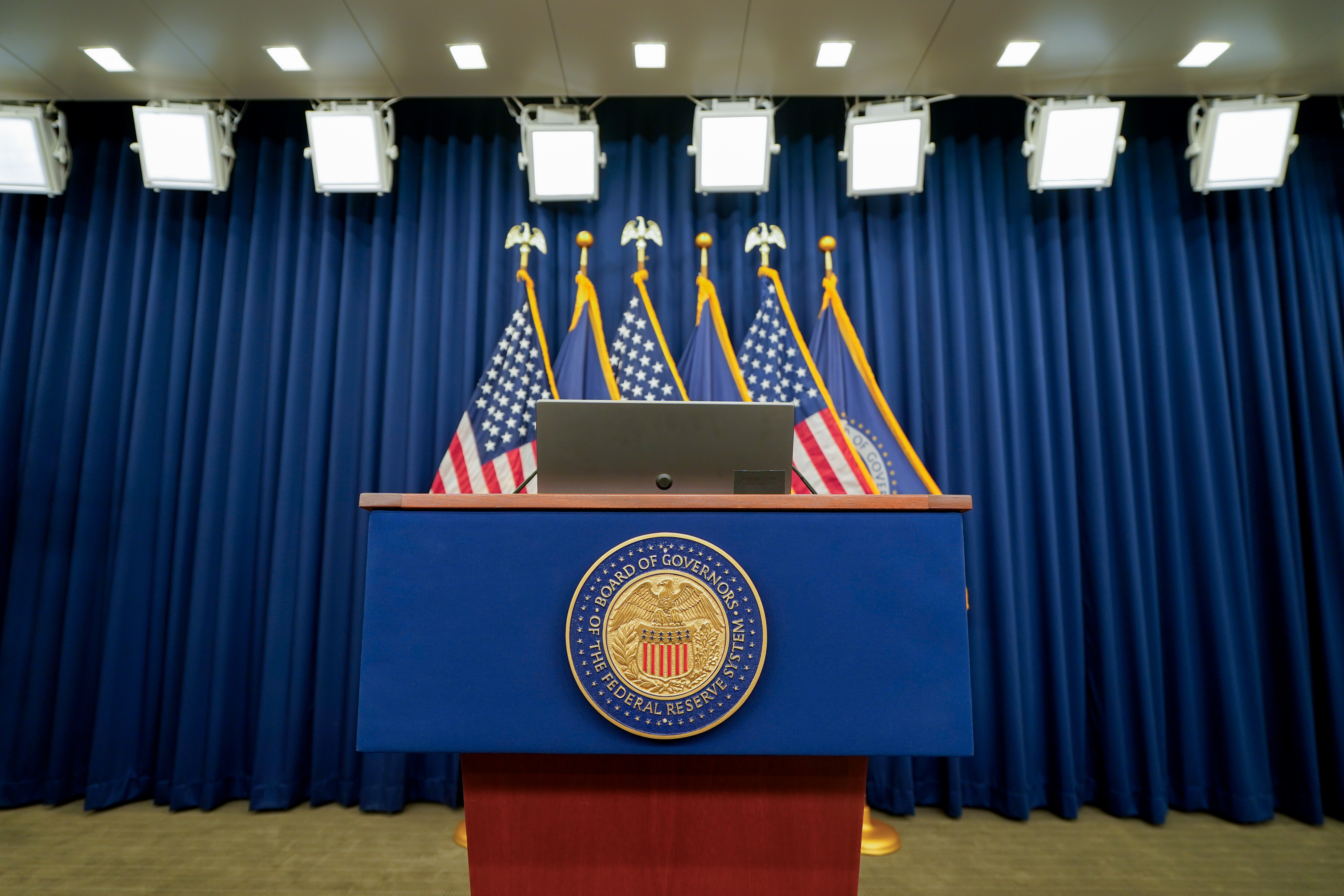 The seal of the Board of Governors of the Federal Reserve System on a podium ahead of a news conference following a Federal Open Market Committee (FOMC) meeting in Washington, DC, US, on Wednesday, July 30, 2025. Federal Reserve officials left interest rates unchanged but downgraded their view of the US economy, a sign policymakers could be edging closer to lowering borrowing costs.